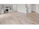 Spacious open-plan living area with hardwood flooring, a modern kitchen, and a staircase at 3340 Redwood Ct, Covington, GA 30016