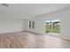 Well-lit living room with hardwood flooring, large windows, and sliding glass doors leading to the yard at 3340 Redwood Ct, Covington, GA 30016