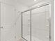 Bathroom featuring modern glass shower and white door at 3650 Olive Grove Ln, Covington, GA 30016