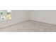 Bright, carpeted bedroom featuring a large window and neutral walls at 3650 Olive Grove Ln, Covington, GA 30016