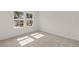 Bright, carpeted bedroom featuring a large window and neutral walls at 3650 Olive Grove Ln, Covington, GA 30016