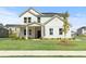 Charming two-story home with white siding, a welcoming front porch, and a well-manicured lawn at 3650 Olive Grove Ln, Covington, GA 30016