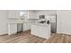 Modern kitchen featuring stainless steel appliances, a center island, and granite countertops at 3650 Olive Grove Ln, Covington, GA 30016