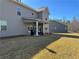 A view of the backyard with patio and exterior home architecture at 3330 Deaton Trl, Buford, GA 30519