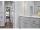 Bright bathroom featuring a white vanity with a sink and a view to an adjacent room at 3330 Deaton Trl, Buford, GA 30519