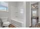 Bright bathroom showcasing a white tub and shower with a window offering natural light at 3330 Deaton Trl, Buford, GA 30519