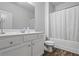 Clean, bright bathroom with white cabinets, a large mirror, and a shower-tub combination at 3330 Deaton Trl, Buford, GA 30519