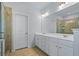 Well-lit bathroom with double sinks and a tiled shower, creating a relaxing and functional space at 3330 Deaton Trl, Buford, GA 30519