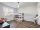 Cozy bedroom with bunk beds, wood floors, and natural light from a large window at 3330 Deaton Trl, Buford, GA 30519