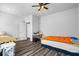 Comfortable bedroom with neutral tones, wood floors, and a door leading to another room at 3330 Deaton Trl, Buford, GA 30519