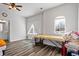 Bedroom featuring natural light, wood-look flooring, and a ceiling fan for added comfort at 3330 Deaton Trl, Buford, GA 30519