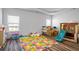 Spacious playroom featuring wood-look floors, windows, and play items at 3330 Deaton Trl, Buford, GA 30519