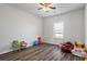 Bright and airy bedroom with wood-look flooring and a ceiling fan for added comfort at 3330 Deaton Trl, Buford, GA 30519
