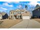 Traditional brick home with attached two-car garage and long driveway at 3330 Deaton Trl, Buford, GA 30519