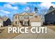 Beautiful brick home featuring manicured lawn, two-car garage and classic architectural details at 3330 Deaton Trl, Buford, GA 30519