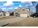 Spacious two-story brick home showcasing a long driveway leading to an attached two-car garage at 3330 Deaton Trl, Buford, GA 30519