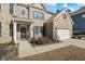 Inviting front entrance features a black front door with a seasonal wreath and manicured landscaping at 3330 Deaton Trl, Buford, GA 30519