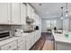 Modern kitchen with stainless steel appliances, white cabinets, and spacious countertops at 3330 Deaton Trl, Buford, GA 30519