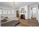 Bright living room with wood floors, a fireplace, large windows, and a comfortable couch at 3330 Deaton Trl, Buford, GA 30519