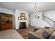 Cozy living room features a fireplace, wooden floors, and a comfortable couch, creating a warm and inviting space at 3330 Deaton Trl, Buford, GA 30519