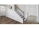 Staircase features wood stairs, iron railings, and light wood floors, creating a seamless transition between levels at 3330 Deaton Trl, Buford, GA 30519