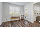 Sunroom featuring a large window, exterior access, and wood-style flooring, providing ample natural light at 3330 Deaton Trl, Buford, GA 30519