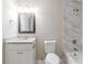 Basement bathroom with white vanity and marble tile at 4412 Rustic Wood Dr, Stone Mountain, GA 30083