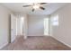 Spacious bedroom with ceiling fan and carpet flooring, multiple entry points at 4412 Rustic Wood Dr, Stone Mountain, GA 30083