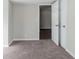 Well-lit bedroom with carpet and door to another room at 4412 Rustic Wood Dr, Stone Mountain, GA 30083