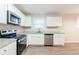 Kitchen with white cabinets, granite countertops, and stainless steel appliances at 4412 Rustic Wood Dr, Stone Mountain, GA 30083