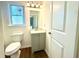 Bathroom featuring a vanity with modern lighting and commode at 3945 Peninsula Ct, Lawrenceville, GA 30044
