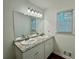 Bathroom featuring double vanity with granite countertop and white cabinets at 3945 Peninsula Ct, Lawrenceville, GA 30044