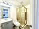 Compact bathroom featuring a walk-in shower, modern vanity, and contemporary fixtures at 3945 Peninsula Ct, Lawrenceville, GA 30044