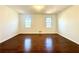 Bright, spacious bedroom featuring hardwood floors and two windows at 3945 Peninsula Ct, Lawrenceville, GA 30044