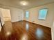 Bright, spacious bedroom featuring hardwood floors and ample natural light at 3945 Peninsula Ct, Lawrenceville, GA 30044
