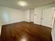 Comfortable bedroom featuring hardwood floors, closet, and natural light at 3945 Peninsula Ct, Lawrenceville, GA 30044