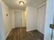 Inviting entryway featuring wood-look flooring and a convenient closet, enhancing the home's functionality at 3945 Peninsula Ct, Lawrenceville, GA 30044