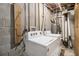 Basement laundry area with a washer and dryer set against a brick wall and visible ceiling pipes at 2418 Brookdale Ne Dr, Atlanta, GA 30345