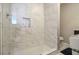 Modern bathroom shower with marble tile and glass enclosure at 2418 Brookdale Ne Dr, Atlanta, GA 30345