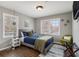 Cozy bedroom with natural light from two windows, hardwood floors, and a comfortable queen bed at 2418 Brookdale Ne Dr, Atlanta, GA 30345