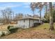 View of backyard with a side view of home, and mature trees creating a picturesque outdoor space at 2418 Brookdale Ne Dr, Atlanta, GA 30345