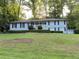 Charming single-story home features a light brick facade, black shutters, and a neatly landscaped front yard at 2418 Brookdale Ne Dr, Atlanta, GA 30345