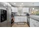 Well-lit kitchen features stainless steel appliances, white cabinetry, and granite countertops at 2418 Brookdale Ne Dr, Atlanta, GA 30345