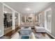 Inviting living room featuring modern gray walls, a large sectional sofa, and a view into the dining area at 2418 Brookdale Ne Dr, Atlanta, GA 30345