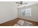 Well-lit bedroom boasts wood-look flooring, a ceiling fan, and a window creating a comfortable and inviting space at 3039 Sable Run Rd, Atlanta, GA 30349