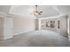 Large main bedroom with carpet, ceiling fan, and bay window at 6315 Sturbridge Ln, Cumming, GA 30040