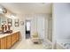 Bright bathroom with a large vanity, framed mirrors, a walk-in shower, and a garden tub at 3258 Kessock Ridge Trl, Snellville, GA 30039