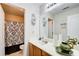 Well-lit bathroom showcasing a shower with patterned curtain and a vanity with décor at 3258 Kessock Ridge Trl, Snellville, GA 30039