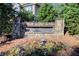 Stone monument sign reading 'Victoria Highlands' with landscaping and colorful flowers at 3258 Kessock Ridge Trl, Snellville, GA 30039