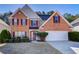 Charming two-story brick home with manicured landscaping and a two-car garage at 3258 Kessock Ridge Trl, Snellville, GA 30039